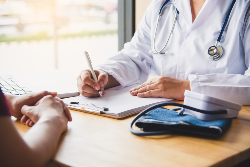 Doctor reviews insurance documentation